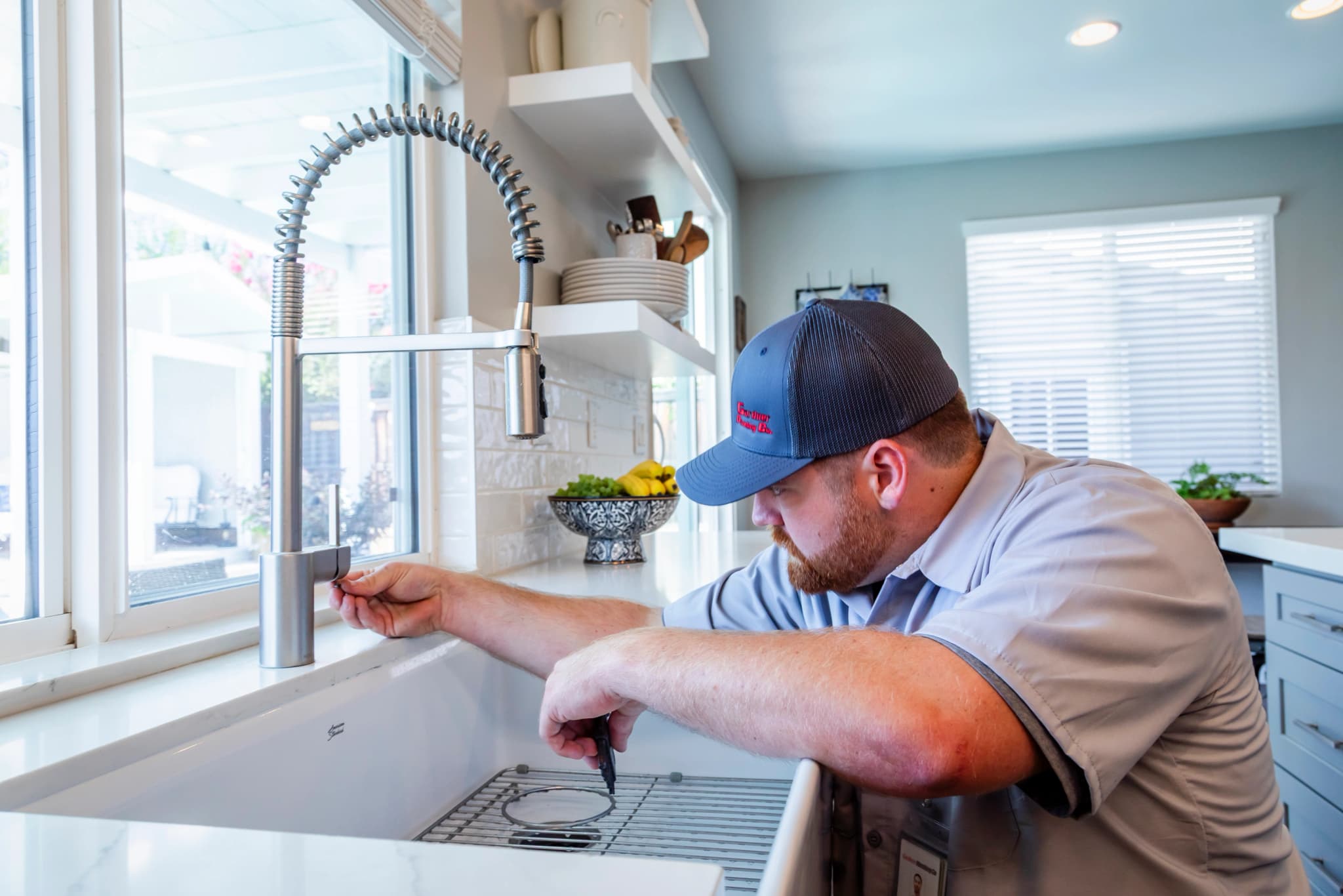 Technician performing a detailed plumbing inspection with a checklist