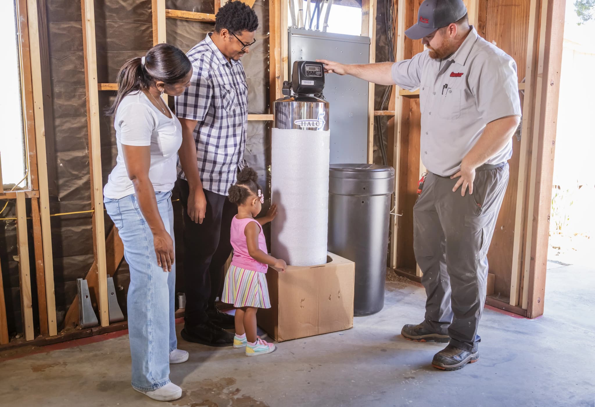 Modern whole house water filtration system installed in a clean garage